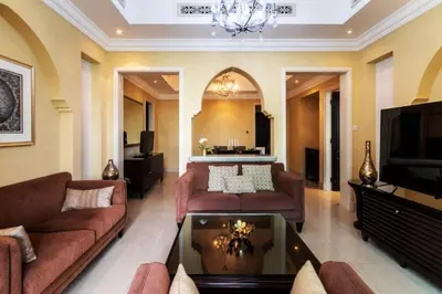a living room with two couches and a tv at Cozy 2BDR Residence in Dubai's Souk Al Bahar in Dubai