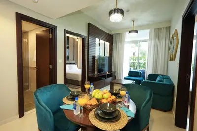 a living room with a table with fruit on it at Vera Tower - 2 Bedroom with Burj Khalifa view in Dubai