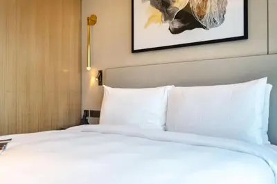 a large white bed in a hotel room at Address Opera - Ultra luxurious 2BDR in Downtown in Dubai