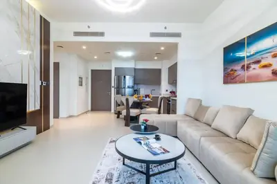 a living room with a couch and a table at The 34th Perch Downtown Retreat 2BDR in Dubai
