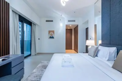 a bedroom with a large white bed and a large window at The 34th Perch Downtown Retreat 2BDR in Dubai