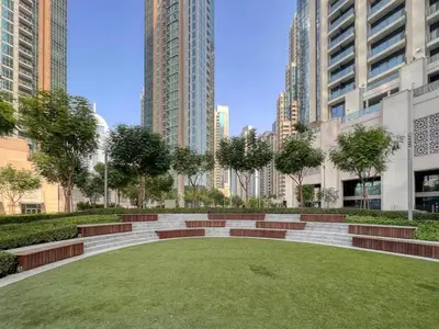 a park in the middle of a city with tall buildings at The 34th Perch Downtown Retreat 2BDR in Dubai