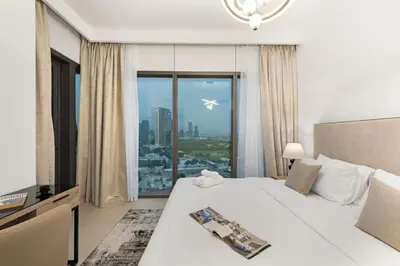 a hotel room with a bed and a large window at Ultimate Luxury 3BDR With Burj Khalifa view in Dubai