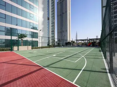 a tennis court in a city with tall buildings at Ultimate Luxury 3BDR With Burj Khalifa view in Dubai