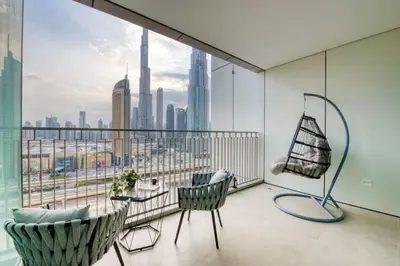 a balcony with chairs and a view of the city at Ultimate Luxury 3BDR With Burj Khalifa view in Dubai