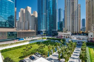 a city skyline with tall buildings and palm trees at LA VIE 1BDR in JBR with Private Beach in Dubai