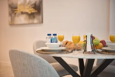a table with food and glasses of orange juice at LA VIE 1BDR in JBR with Private Beach in Dubai