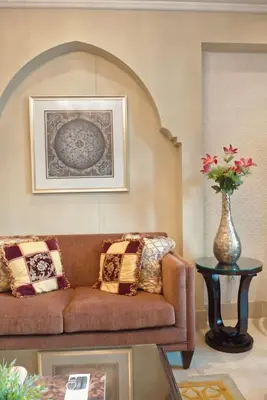 a living room with a couch and a vase with flowers at Gorgeous 1BDR with Burj Khalifa & Fountain Views in Dubai