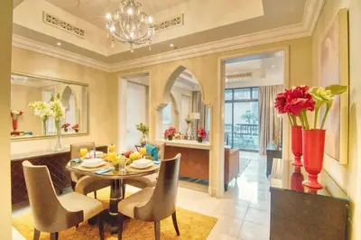 a dining room with a table and chairs at Gorgeous 1BDR with Burj Khalifa & Fountain Views in Dubai