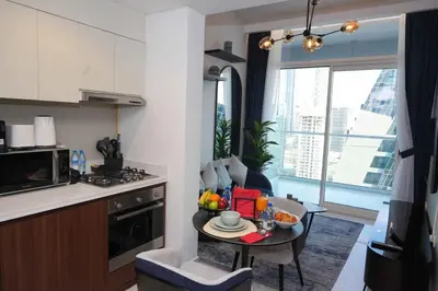 a kitchen with a table with a bowl of fruit on it at Brand new 1BDR in Vera- Business Bay in Dubai