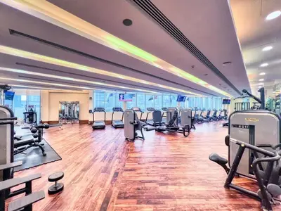 a gym with several treadmills and cardio machines at Luxurious Studio Flat with Burj Khalifa Views in Dubai