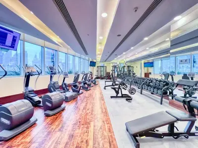 a gym with treadmills and elliptical machines at Luxurious Studio Flat with Burj Khalifa Views in Dubai