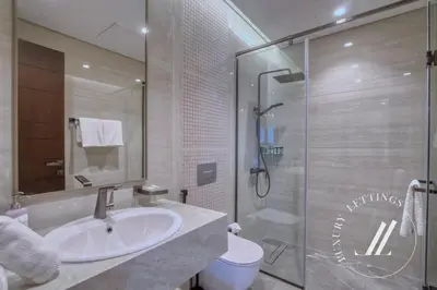 a bathroom with a sink and a shower at Luxury 2BDR Apartment with Private Balcony in Dubai