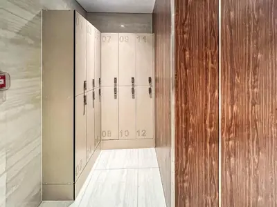 a locker room with a row of lockers at Luxury 2BDR Apartment with Private Balcony in Dubai