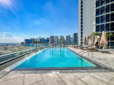 a swimming pool on the roof of a building at Luxury 2BDR Apartment with Private Balcony in Dubai