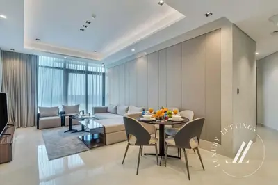 a living room with a couch and a table at Luxury 2BDR Apartment with Private Balcony in Dubai