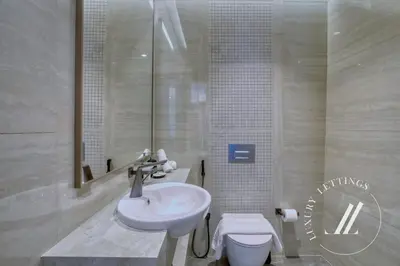 a bathroom with a sink and a toilet at Luxury 2BDR Apartment with Private Balcony in Dubai
