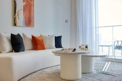 a living room with a couch and a table at Grand Bleu Tower 2 - 1 BDR with Beachfront Views in Dubai