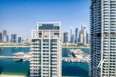 two tall buildings next to the water in a city at Grand Bleu Tower 2 - 1 BDR with Beachfront Views in Dubai
