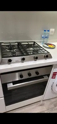 a stove top oven sitting in a kitchen at Studio Apartment Near downtown Dubai in Dubai
