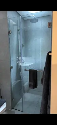 a shower with a glass door in a bathroom at Studio Apartment Near downtown Dubai in Dubai