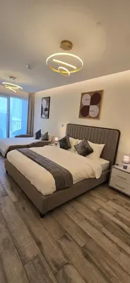 a bedroom with a large bed in a room at Studio Apartment Near downtown Dubai in Dubai