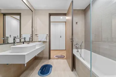 a bathroom with two sinks and a shower at Luxury 2 BR Spectacular Downtown and Sea View next to metro in Dubai
