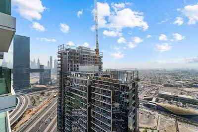 a tall building with a crane in a city at Luxury 2 BR Spectacular Downtown and Sea View next to metro in Dubai