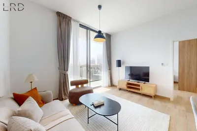 a living room with a couch and a table at Brand New and Modern 1BR in Dubai