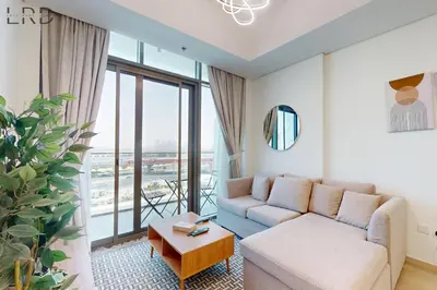 a living room with a couch and a table at Modern 1BR with Canal View in Dubai