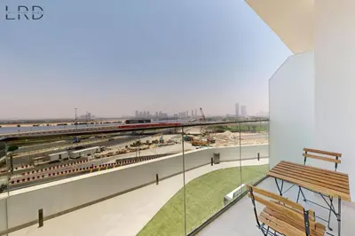 a balcony with a view of a train station at Modern 1BR with Canal View in Dubai