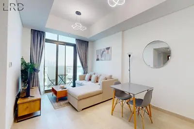 a living room with a couch and a table at Cozy 1BR with Canal View in Dubai