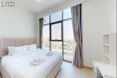 a bedroom with a bed with two towels on it at Cozy 1BR with Canal View in Dubai
