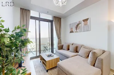 a living room with a couch and a table at Charming 1BR with Canal View in Dubai