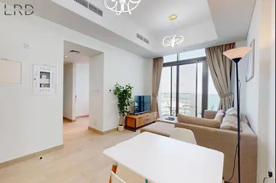 a living room with a couch and a table at Charming 1BR with Canal View in Dubai