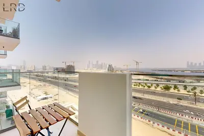 a balcony with two chairs and a view of a highway at Charming 1BR with Canal View in Dubai