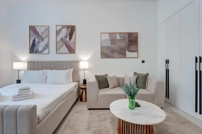 a living room with a bed and a couch and a table at PVH - Contemporary Studio - Prime Residency 3 in Dubai