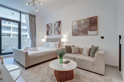 a living room with a couch and a table at PVH - Contemporary Studio - Prime Residency 3 in Dubai