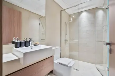 a bathroom with a white sink and a shower at PVH - Chic 1BR in Azizi Riviera 37 in Dubai