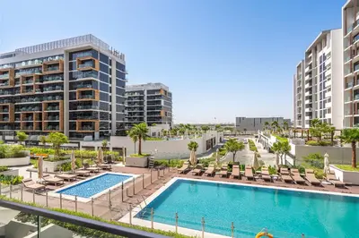 an image of a pool with chairs and buildings at PVH - Chic 1BR in Azizi Riviera 37 in Dubai