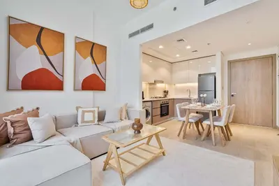 a living room with a couch and a table at PVH - Chic 1BR in Azizi Riviera 37 in Dubai