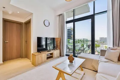 a living room with a couch and a tv at PVH - Chic 1BR in Azizi Riviera 37 in Dubai