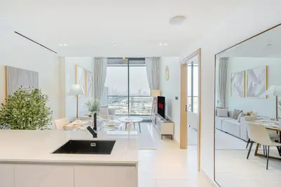 a kitchen and living room with a couch and a table at PVH - Vibrant 1BR - Binghatti Corner in Dubai