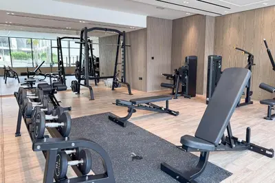 a gym with a bunch of treadms and machines at PVH - Vibrant 1BR - Binghatti Corner in Dubai