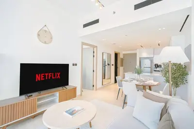 a living room with a couch and a tv at PVH - Vibrant 1BR - Binghatti Corner in Dubai