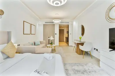a white living room with a white bed and a couch at PVH - Chic Furnished Studio in JLT - Me Do Re in Dubai