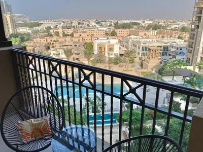 a balcony with chairs and a view of a city at Rahaal 1 BDR, Madinat Jumeirah in Dubai