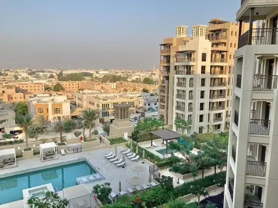 a view of a city with a pool and buildings at Rahaal 1 BDR, Madinat Jumeirah in Dubai