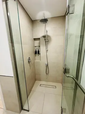 a bathroom with a shower with a glass door at Rahaal 1 BDR, Madinat Jumeirah in Dubai