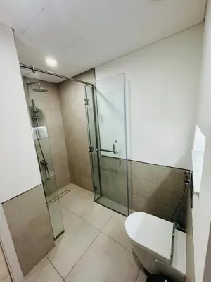 a bathroom with a glass shower and a toilet at Rahaal 1 BDR, Madinat Jumeirah in Dubai